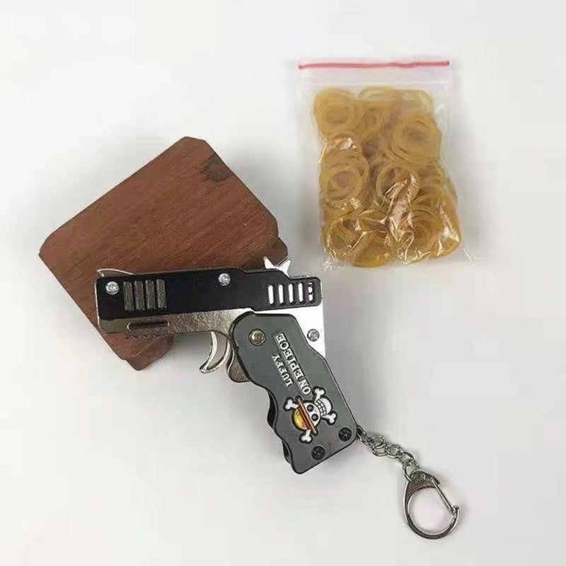 One Piece Mini Folding Rubber Band Gun Keychain, Straw Hat Pirates Jolly Roger Metal Rubber Band Launcher Toy, Portable Foldable Key Ring Collectible Ornament, Anime Fan Desk Decor & Gift